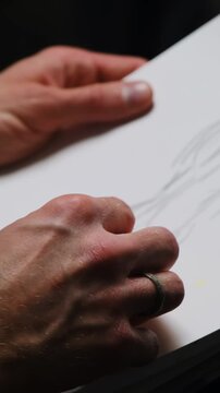 Man uses sketching technique drawing mannequin on sheet. Guy works on creating silhouette and uses special tool spending time in creative club
