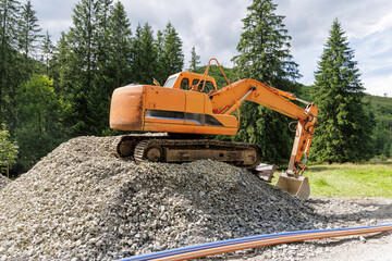 Excavator on a Pile of Rocks
