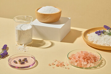Clean and minimal shot of skincare jars, bath salts, and lavender on small white podiums for modern spa product branding. Photo for advertising body care product