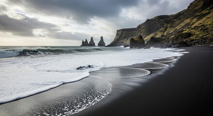 Dramatic Black Sand Beach and Basalt Sea Stacks of Iceland Coastline Under a Cloudy Sky