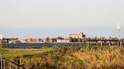 view of the lagoon inside the Po river Delta with the Comacchio village in the background, Ferrara,...