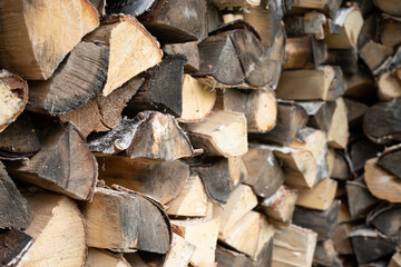 Woodpile. Birch firewood. Chopped firewood. Rows of chopped firewood.