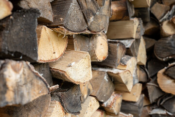 Woodpile. Birch firewood. Chopped firewood. Rows of chopped firewood.