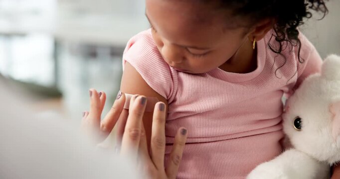 Hands, doctor and plaster on kid at hospital for first aid, injection and virus vaccination. Pediatrician, helping and child with bandage for medical checkup, immunization shot and wound protection
