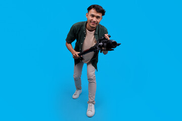 Happy Young Videographer Man Smiling While Holding A Camera On A Gimbal Stabilizer