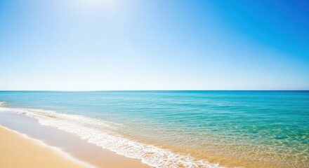 Blurred beach scene, clear blue sky, soft waves