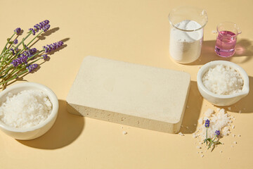 Lavender flowers and bath salts with glass oil bottles arranged on a beige background, perfect for natural skincare and spa promotional photography. Blank space for presentation product