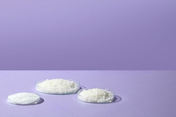 Minimal shot on purple background with three round soap bars or bath salts for a modern clean beauty aesthetic. Blank space for add text and design