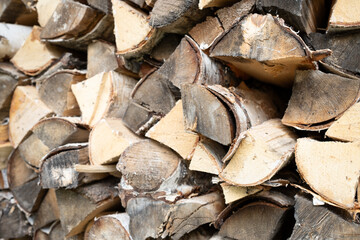 Details of chopped birch logs with birch bark. Woodpile. Birch firewood. Chopped firewood. Texture...