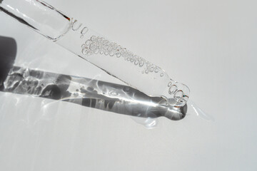 An eyedropper with a drop of oil or a cosmetic product for face and body. Natural organic...