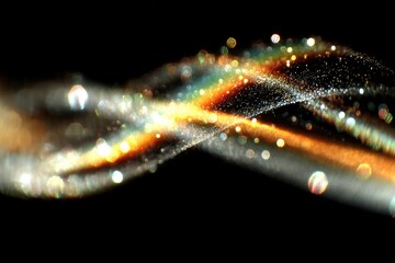 Abstract swirling golden particles on black background