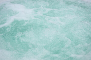 blue water in the bath with white foam.