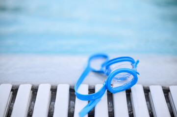 swimming glasses and water drops on the pool