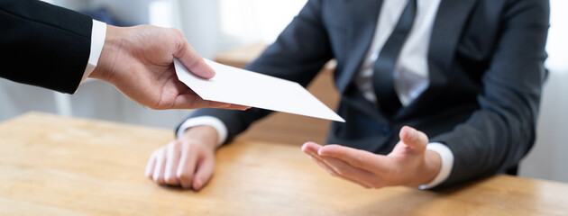 Close up view of boss giving commission bonus to office worker.