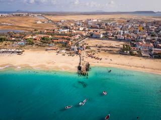 Aerial drone shot of the Santa Maria pier and beach, Sal Island, Cape Verde, at golden sunset....