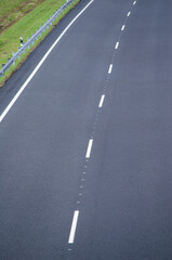 A clean and new highway with a guardrail, a theme of safety and infrastructure.