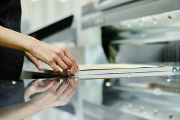 Hands of unrecognizable printing house worker adjusting pile of printouts on desk, copy space