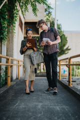 A professor and a student converse while walking in a school courtyard discussing assignments.