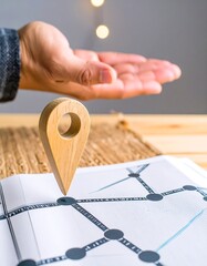 Hand hovering over a wooden location marker on a map