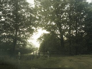 old bridge over river on rainy day