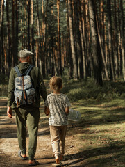 Fototapeta premium father and daughter walking in the forest
