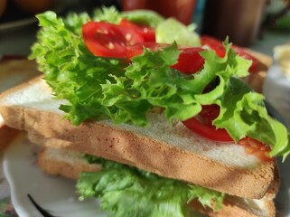 Homemade sandwich. Homemade sandwich with vegetables. Sandwich with tomato, cucumber and lettuce....