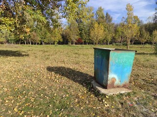 Garbage can in the park. Ecology. Clean environment. Trash can. Old rusty garbage can