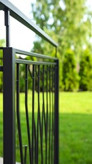 Modern black metal fence detail in a backyard