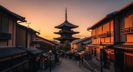 Obraz premium Sunrise over a traditional Japanese street. A view of a sloped street, lined with traditional wooden buildings, leading to a towering pagoda at sunrise. Warm golden light bathes the scene