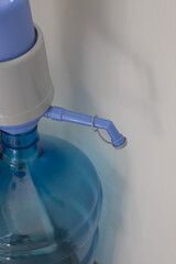 Drinking water dispenser with pump on light background