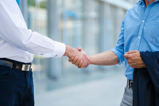 Business partners shaking hands after successful meeting