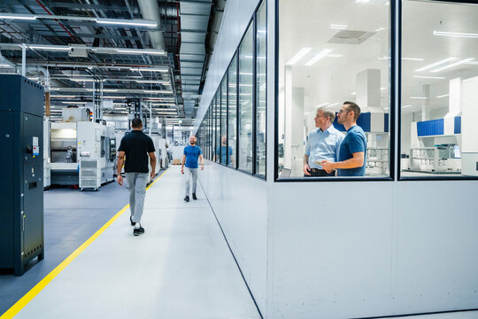 Businessman and employees in a factory
