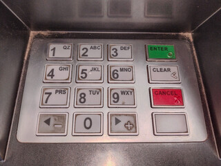 Close-up photo of ATM machine showing full keypad layout area used for secure banking transactions...