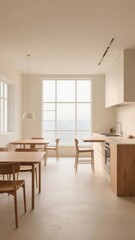 Modern minimalist kitchen and dining area with large windows overlooking the sea