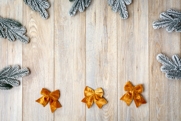 Snowy Christmas fir branches, sparkling ornaments, and festive gift on cozy rustic wooden table