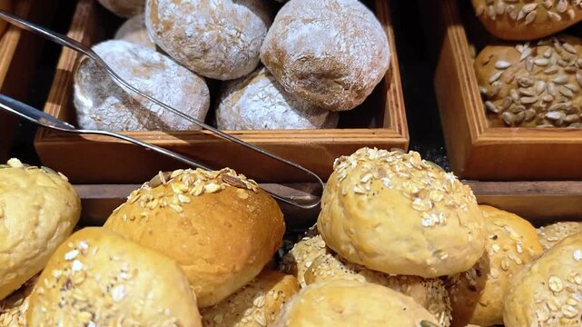 Assortment of fresh bread rolls served in a basket for breakfast buffet at hotel.