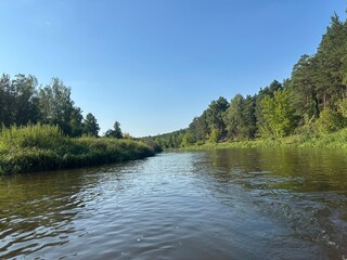 Kayaking adventure in the Nida Valley, surrounded by lush greenery and calm river waters. The photo captures the outdoor activity, scenic landscape, and peaceful nature experience.