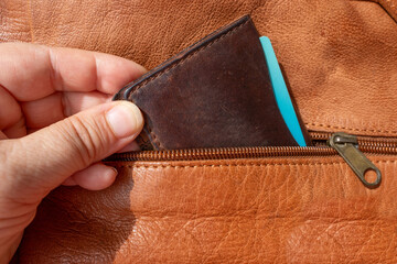 Hand thief pulling wallet from bag pocket, pickpocketing scene, Pickpocket stealing wallet, danger...