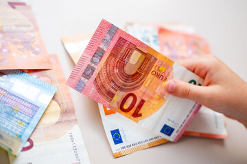 Little girl child, preschooler, primary school student, holding money, cash euros banknotes, hands...