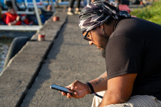 Traveler checking smartphone near Sierpe River, Costa Rican tropical landscape surrounding