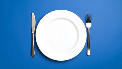 Empty White Plate, Knife, and Fork on Vibrant Blue Background