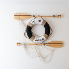 Maritime-themed decoration with a white and black life preserver ring inscribed 