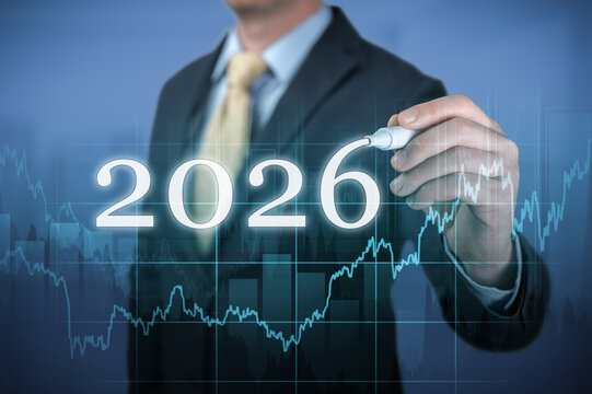 Businessman drawing growing virtual hologram of statistics, graph and chart for new year 2026 business growth and financial planning concept