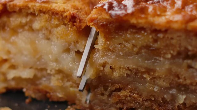 Extreme close-up shot. A fork cuts a slice of homemade apple pie, breaking the crispy, flaky crust and revealing the warm, juicy apple filling. A tempting dessert moment