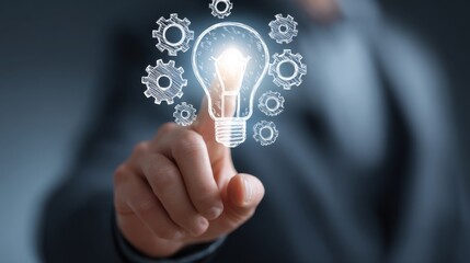 A person's finger touches a glowing lightbulb surrounded by gears, symbolizing innovation and ideas.