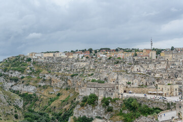 Matera – Panoramic View of Sassi District with Chiesa di San Pietro Caveoso on Rocky Cliff,...