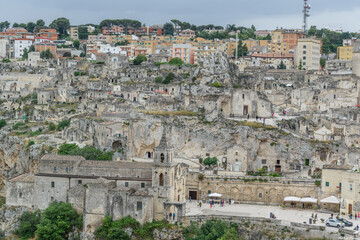 Matera – Panoramic View of Sassi District with Chiesa di San Pietro Caveoso on Rocky Cliff,...