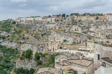 Matera – Panoramic View of Sassi District with Chiesa di San Pietro Caveoso on Rocky Cliff,...