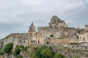Matera – Panoramic View of Sassi District with Chiesa di San Pietro Caveoso on Rocky Cliff,...
