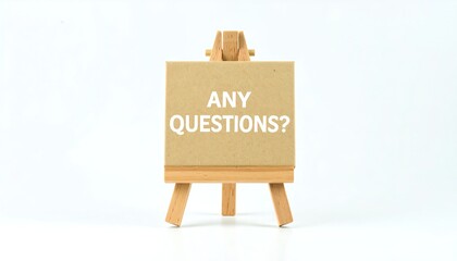 Wooden Easel Displaying "Any Questions?" on a Neutral Background.